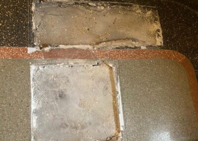 A tile floor with a hole in the middle of it