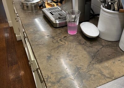 A kitchen counter with a coffee maker and other items on it